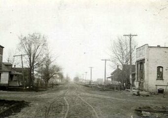 Historic small town street with old buildings and trees.